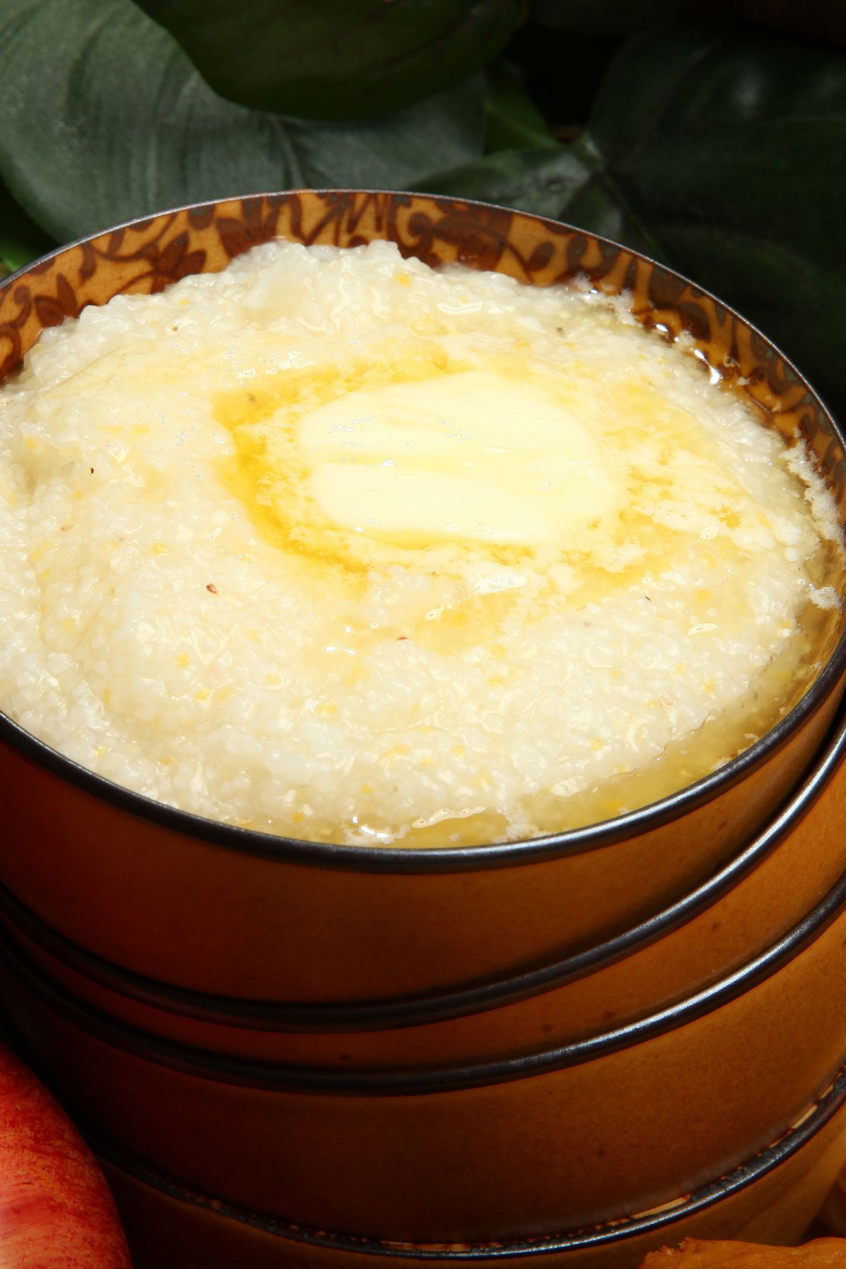 Closeup of Ultimate Southern Cheese Grits in a brown bowl.