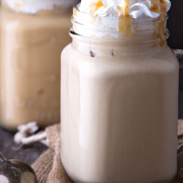 2 Copycat Starbucks Caramel Frappuccinos in mason jars.
