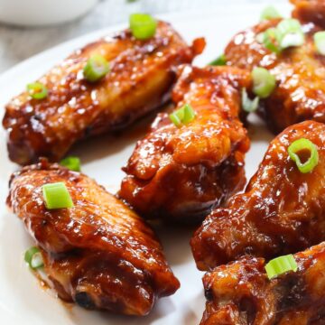 Grilled Asian Honey Chicken Wings on a white plate.