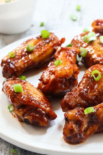 Grilled Asian Honey Chicken Wings on a white plate.