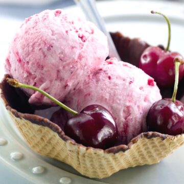 2 scoops of Homemade Cherry Ice Cream in a waffle bowl.