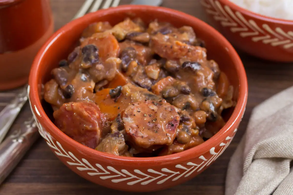 Simple Black Bean and Pork Stew in an orange and white bowl.