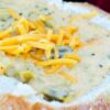 Closeup of Broccoli Cheddar Soup (Panera Copycat) in a bread bowl.