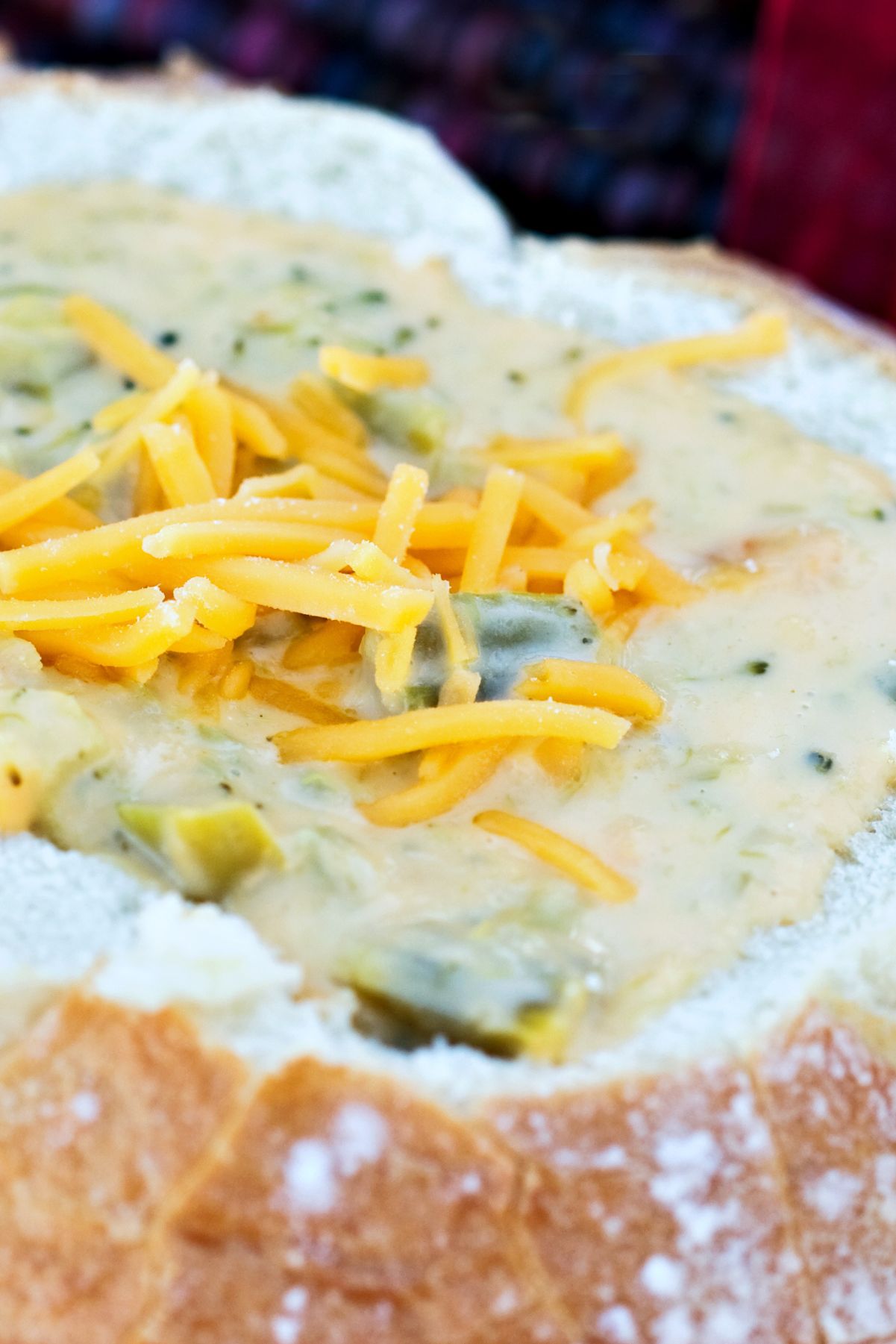 Closeup of Broccoli Cheddar Soup (Panera Copycat) in a bread bowl.