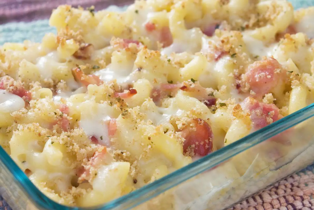 Sausage Macaroni and Cheese Casserole in a clear glass casserole dish.