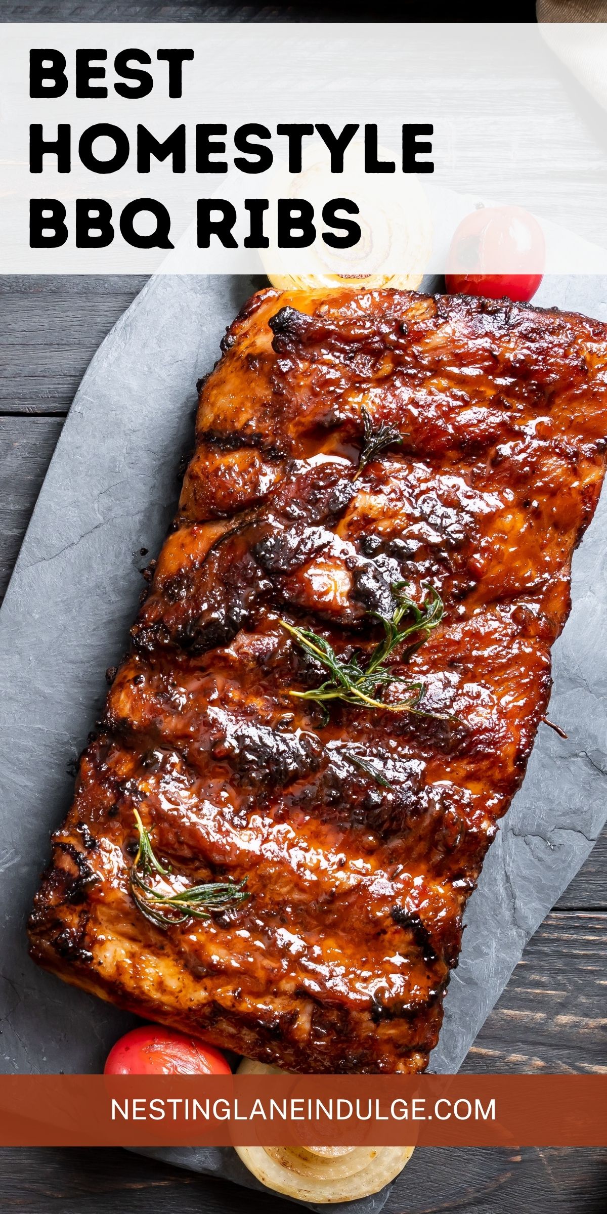 A rack of BBQ ribs with sauce on parchment, garnished with rosemary, next to onions and tomatoes on a wooden table. Text reads "Best Homestyle BBQ Ribs, NESTINGLANEINDULGE.COM."