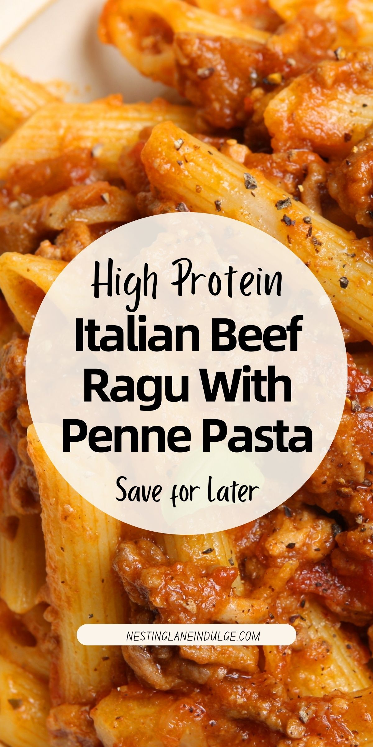 Close-up of high protein Italian beef ragu with penne pasta coated in rich tomato sauce and tender ground beef, sprinkled with black pepper. White circle text overlay reads &ldquo;High Protein Italian Beef Ragu With Penne Pasta Save for Later&rdquo; and &ldquo;NESTINGLANEINDULGE.COM.&rdquo; Hearty comfort food pasta dinner recipe.