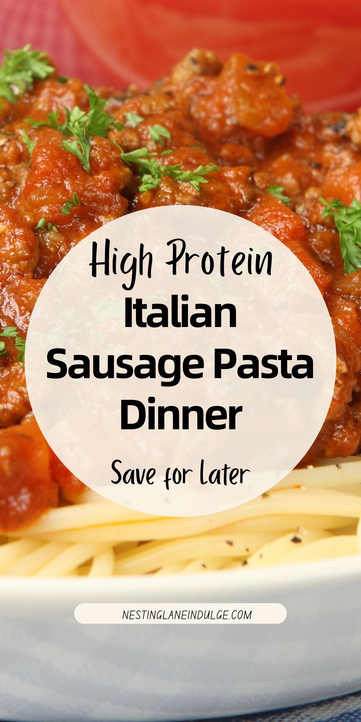 Close-up of high protein Italian sausage pasta dinner with spaghetti topped in rich tomato sauce, chunks of Italian sausage, and fresh chopped parsley. White text overlay reads “High Protein Italian Sausage Pasta Dinner” and “nestinglaneindulge.com.” Hearty comfort food pasta recipe for an easy family dinner.