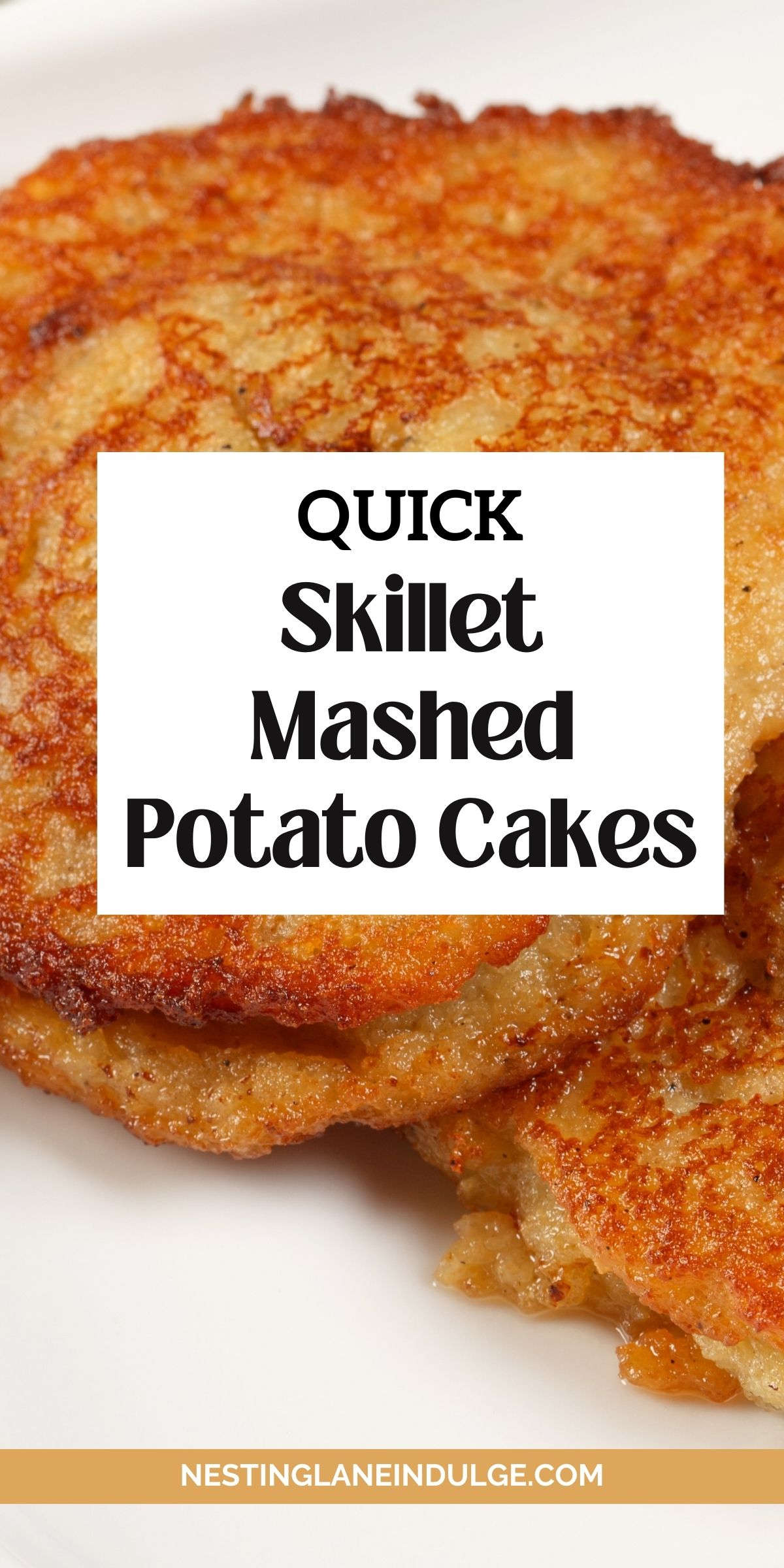 Close-up of golden brown skillet mashed potato cakes with crispy edges on a white plate. White text overlay reads &ldquo;Quick Skillet Mashed Potato Cakes&rdquo; and &ldquo;NESTINGLANEINDULGE.COM.&rdquo; Easy pan fried potato patties made from leftover mashed potatoes, crunchy outside and tender inside.
