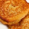 Close-up of crispy skillet mashed potato cakes stacked on a white plate, golden brown with crunchy edges and tender centers. Pan fried potato patties made from leftover mashed potatoes, lightly seasoned and perfectly browned for an easy comfort food side dish.